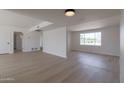 Bright, airy living room with wood floors and a large window at 14803 N 55Th Ave, Glendale, AZ 85306
