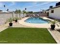Sparkling pool with beach ball and lush landscaping create a backyard oasis at 14803 N 55Th Ave, Glendale, AZ 85306