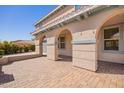 Paved patio area featuring elegant arches and posts providing shade and architectural detail at 21256 E Waverly Dr, Queen Creek, AZ 85142