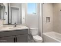 Well-lit bathroom featuring a shower/tub and a gray vanity with a white countertop at 21288 N 272Nd Ln, Buckeye, AZ 85396