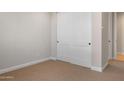 Neutral bedroom featuring carpet and a closet with paneled sliding doors at 21288 N 272Nd Ln, Buckeye, AZ 85396
