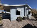 Well-maintained home featuring desert landscaping and functional window shutters at 2233 E Behrend Dr # 85, Phoenix, AZ 85024