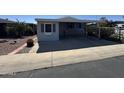 Single-story home exterior with ample parking under the covered carport at 2233 E Behrend Dr # 85, Phoenix, AZ 85024