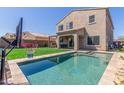 Beautiful backyard with a refreshing pool, lush turf, and a built-in outdoor grill area at 2765 E Gillcrest Rd, Gilbert, AZ 85298