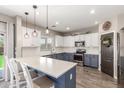 Well-lit kitchen with two-tone cabinets, a modern countertop, and stainless steel appliances at 2765 E Gillcrest Rd, Gilbert, AZ 85298