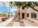 Neutral-toned building exterior featuring private entryways and desert landscaping for a modern feel at 29606 N Tatum Blvd # 121, Cave Creek, AZ 85331