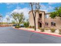 Apartment building featuring exterior stairs and mature trees for a modern, inviting look and feel at 29606 N Tatum Blvd # 121, Cave Creek, AZ 85331