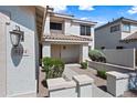 Exterior view of a home entrance with a stone facade, desert landscaping, and clear address numbers at 3144 W Maya Way, Phoenix, AZ 85083