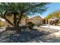 Charming single-story home with a neutral color scheme, desert landscaping, and a two-car garage at 399 W Buena Vista Dr, Tempe, AZ 85284
