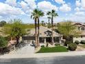 Charming single-Gathering home featuring a well-manicured lawn and mature palm trees in a desirable neighborhood at 42476 W Chisholm Dr, Maricopa, AZ 85138