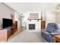 Bright living room showcasing a decorative fireplace and an armchair at 5525 E Thomas Rd # N5, Phoenix, AZ 85018