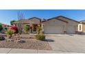 Attractive single-story home showcasing desert landscaping, an American flag, and a three-car garage at 6022 W Fetlock Trl, Phoenix, AZ 85083