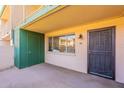 Private patio entrance with secure door and view of well-maintained complex at 6565 N 19Th Ave # 59, Phoenix, AZ 85015