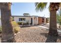 Charming single-story home featuring a desert-friendly landscaped front yard and a quaint patio area at 825 W 12Th St, Tempe, AZ 85281