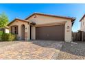 Cozy single-story home with desert landscaping and a brick-paved driveway, creating a clean and inviting exterior at 8515 W Peppertree Ln, Glendale, AZ 85305
