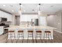 Kitchen featuring granite countertops, a farmhouse sink, pendant lighting, and seating at the island at 8515 W Peppertree Ln, Glendale, AZ 85305
