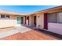 Inviting single-story home featuring brick accents, covered entry, and well-lit walkway at 10420 W Tropicana Cir, Sun City, AZ 85351