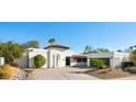 Contemporary white home with a red tile roof, desert landscaping and a circular driveway at 10905 E San Salvador Dr, Scottsdale, AZ 85259