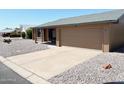 View of home with a long driveway, neutral exterior, xeriscaping and a two car garage at 1132 S 81St Pl, Mesa, AZ 85208