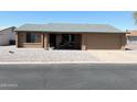 Inviting single-story home with xeriscaped front yard and covered porch with seating area at 1132 S 81St Pl, Mesa, AZ 85208