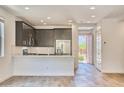 Open kitchen and entryway featuring stainless steel appliances, sleek cabinets, and lots of light at 12542 W Cassia Trl, Peoria, AZ 85383