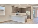 Modern kitchen featuring stainless steel appliances and a bright, white quartz countertop at 12542 W Cassia Trl, Peoria, AZ 85383