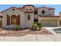 Two story stucco house with a terracotta roof and a two car garage at 12603 W Blackstone Ln, Peoria, AZ 85383