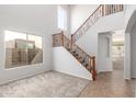 Bright entryway featuring staircase with wood and black wrought iron at 12603 W Blackstone Ln, Peoria, AZ 85383
