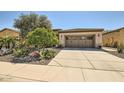 Charming home with a well-maintained desert landscape and a spacious two-car garage at 13055 W Cliffrose Rd, Peoria, AZ 85383