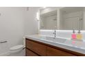 Modern bathroom with wood cabinets, large mirror, and sleek fixtures at 14950 W Mountain View Blvd # 5107, Surprise, AZ 85374