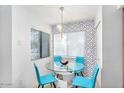 Cozy breakfast nook featuring a glass-top table, accent chairs, pendant lighting, and natural light at 15252 N 100Th St # 2141, Scottsdale, AZ 85260