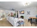 Bright living room featuring plush seating, fireplace, ceiling fan, dining table and eye-catching accent wall at 15252 N 100Th St # 2141, Scottsdale, AZ 85260