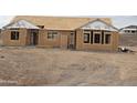 New home under construction featuring wood framing, window openings, and Tyvek weather barrier at 1800 W Caramel Ct, Queen Creek, AZ 85144