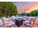 Inviting outdoor fire pit area surrounded by comfortable seating, perfect for relaxing evenings and gatherings at 19793 N Tapestry Ct, Surprise, AZ 85374