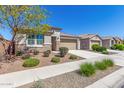 Well-maintained single-level home featuring desert landscaping and a concrete driveway leading to a two-car garage at 22854 E Pummelos Rd, Queen Creek, AZ 85142