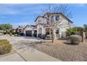 Charming two-story home featuring a three-car garage, desert landscaping, and a welcoming facade at 2417 W Apache Rain Rd, Phoenix, AZ 85085