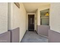 Inviting covered entryway with decorative security door and sidelight window at 2417 W Apache Rain Rd, Phoenix, AZ 85085