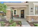 Charming front porch features decorative iron door, bench, stacked stone accents, and well-maintained landscaping at 2512 E Vermont Dr, Gilbert, AZ 85295