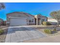 Charming single-story home featuring stone accents, a two-car garage, and low maintenance desert landscaping at 30116 W Fairmount Ave, Buckeye, AZ 85396