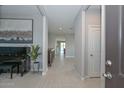 Elegant hallway with tile flooring, neutral paint and natural lighting, leading to the main living areas at 30116 W Fairmount Ave, Buckeye, AZ 85396