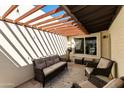 Cozy outdoor patio featuring a pergola, comfortable seating, and ample natural light at 322 W Laguna Dr, Tempe, AZ 85282