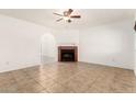 The living room has neutral paint, tile flooring, and a red brick fireplace at 4233 W Paradise Dr, Phoenix, AZ 85029