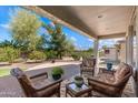 Relaxing outdoor patio space with comfortable seating and a beautifully landscaped backyard at 4542 E Carob Dr, Gilbert, AZ 85298