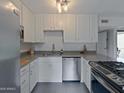 Modern kitchen featuring stainless steel appliances, white cabinetry and gray countertop at 4950 N Miller Rd # 248, Scottsdale, AZ 85251