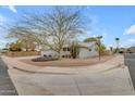 Attractive single-story home featuring low-maintenance desert landscaping and a two-car garage at 5165 E Tunder Dr, Phoenix, AZ 85044