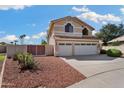 Two-story home featuring a three-car garage and well-maintained landscaping at 5471 W Quail Ave, Glendale, AZ 85308