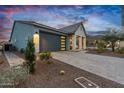 Modern single-story home with stylish garage and desert landscaping at 5644 N 206Th Gln, Buckeye, AZ 85396