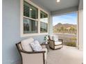 Cozy front porch with comfortable seating and view of the neighborhood and mountains at 5644 N 206Th Gln, Buckeye, AZ 85396