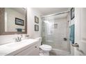 Updated bathroom featuring a glass-enclosed shower, modern vanity, and stylish decorative accents at 7516 E Christmas Cholla Dr, Scottsdale, AZ 85255
