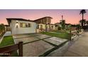 Attractive home with stylish brickwork, green lawn, and a patterned driveway at 8233 E Hubbell St, Scottsdale, AZ 85257